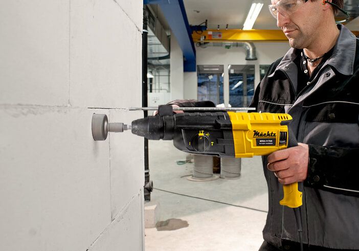 Майстер працює перфоратором по стіні